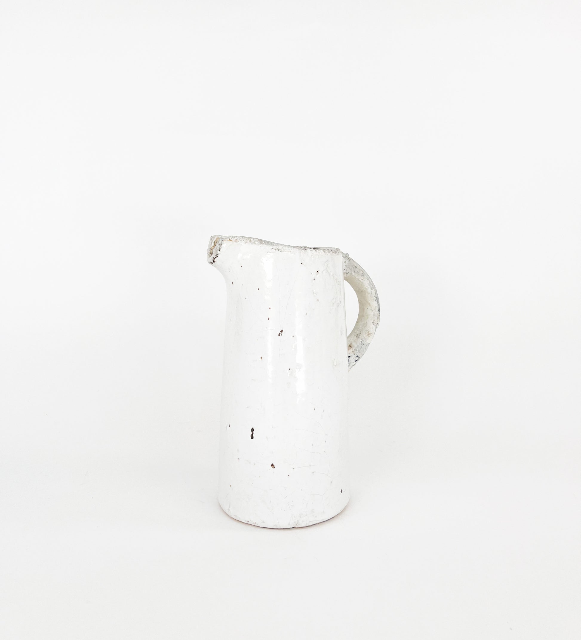 white ceramic pitcher on white backdrop, white vase, ceramic pitcher vase, vintage inspired pitcher vase, gardening vase, spring decor, vintage inspired decor, vintage home decor